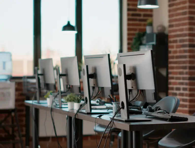 a desk with 4 monitors on top of it