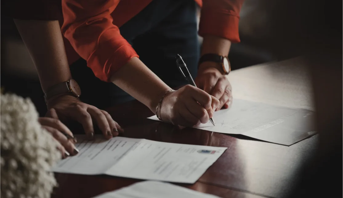 man and woman signing documents