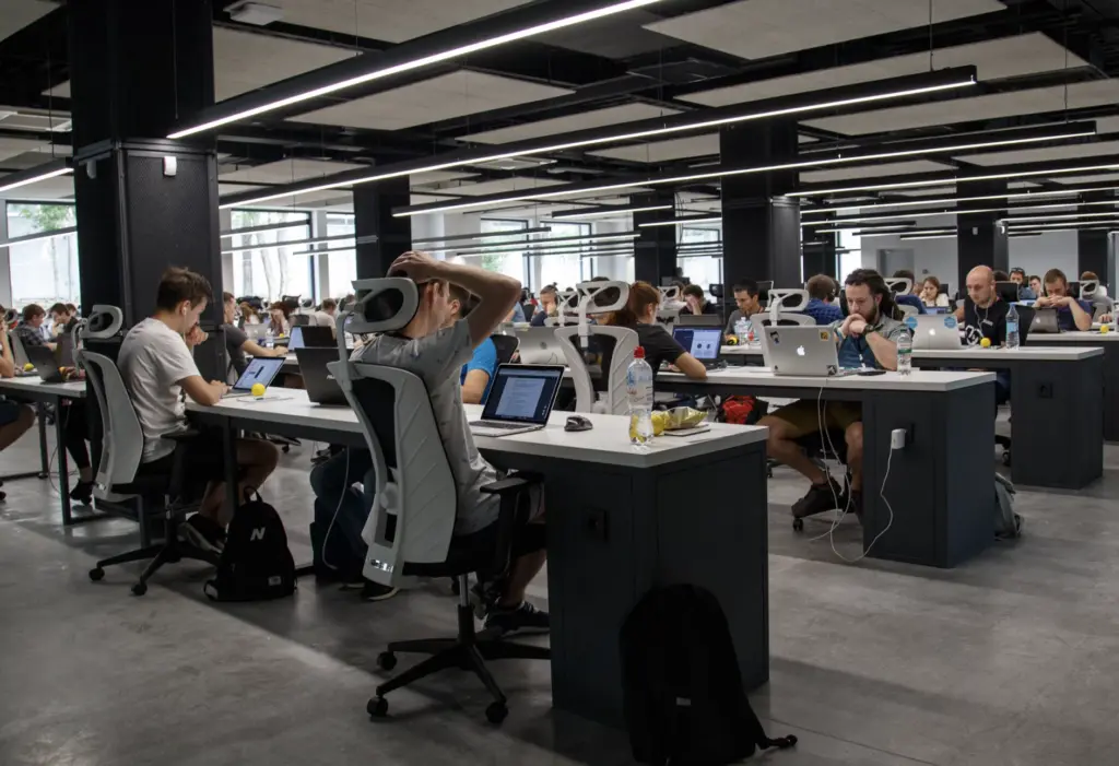 office with many desks and people working on computers